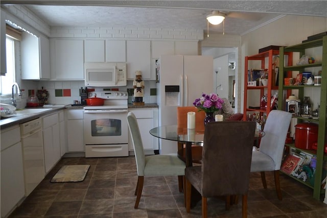 kitchen with crown molding, sink, white cabinets, and white appliances