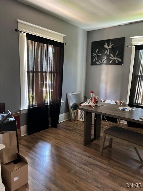 dining space featuring dark wood-type flooring