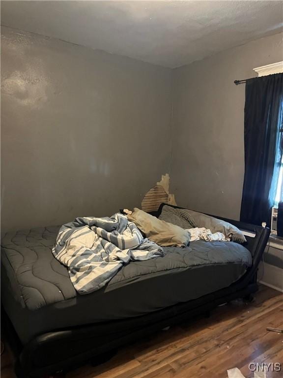 bedroom with hardwood / wood-style floors