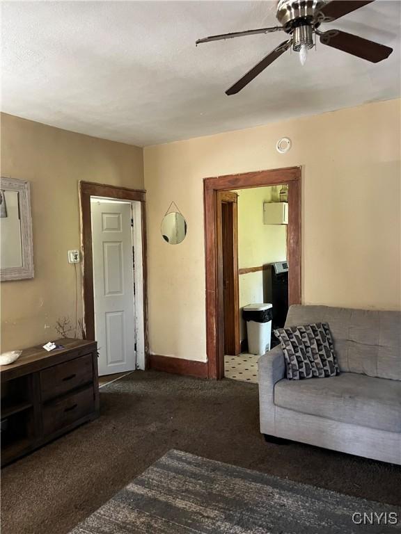 living room with carpet flooring and ceiling fan