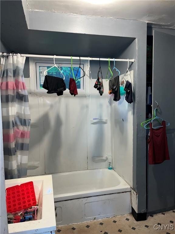 bathroom with shower / bath combo with shower curtain