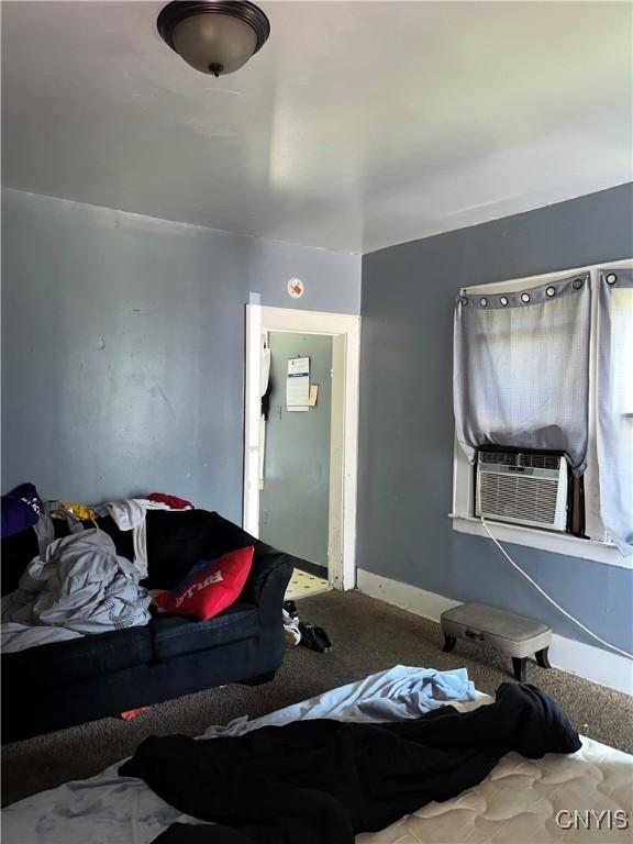 bedroom featuring cooling unit and carpet floors