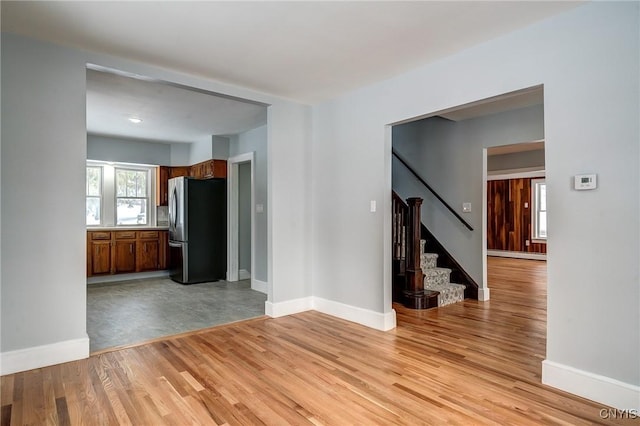 interior space with a baseboard heating unit and light hardwood / wood-style floors