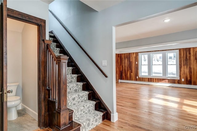 stairs featuring hardwood / wood-style flooring and baseboard heating