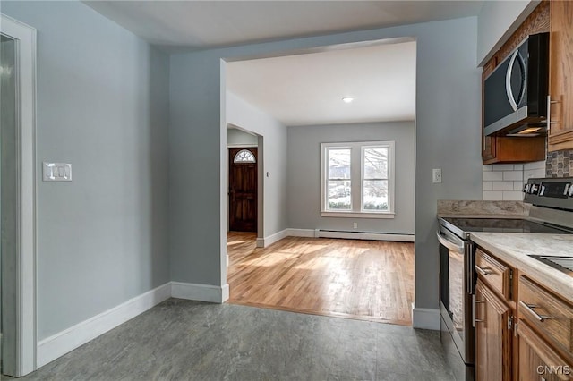 kitchen with tasteful backsplash, electric range, baseboard heating, and light hardwood / wood-style flooring