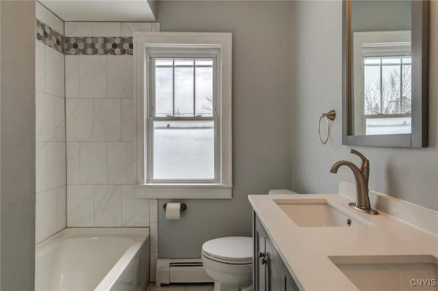 full bathroom featuring vanity, toilet, tiled shower / bath combo, and a baseboard heating unit