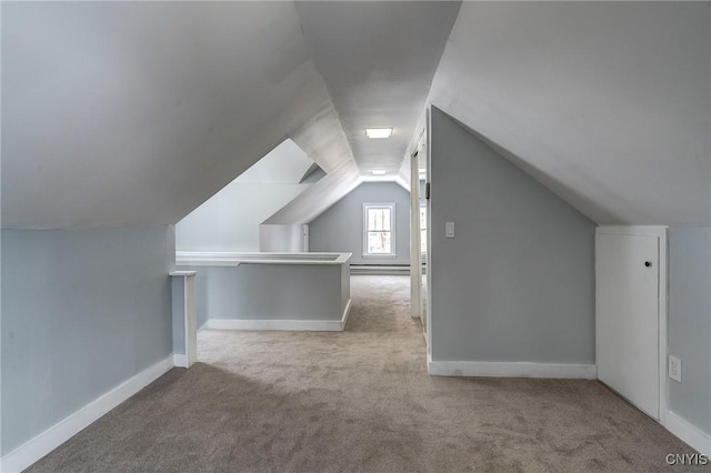 additional living space featuring light colored carpet, lofted ceiling, and a baseboard heating unit