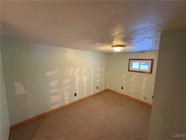 basement featuring a textured ceiling and carpet flooring