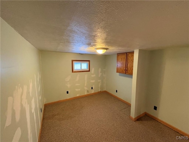 basement with light colored carpet and a textured ceiling