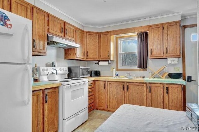 kitchen with crown molding, white appliances, light tile patterned flooring, and sink