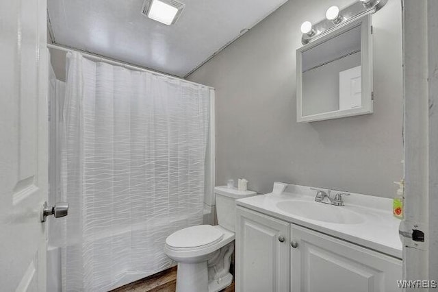 full bathroom featuring hardwood / wood-style flooring, vanity, shower / bath combo, and toilet