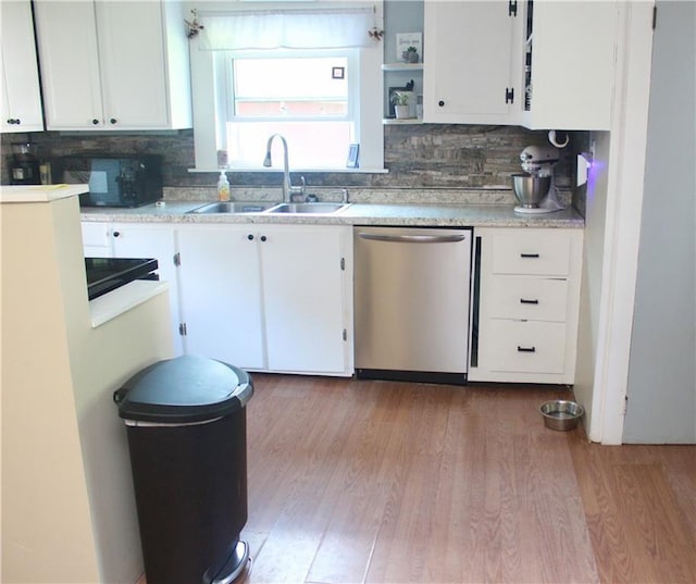 kitchen with sink, stainless steel dishwasher, and white cabinets