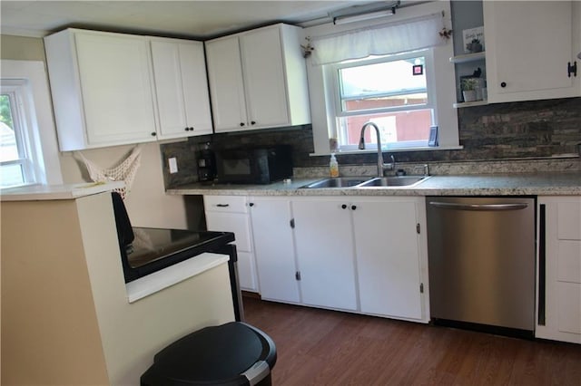 kitchen featuring dark wood-type flooring, sink, stainless steel dishwasher, white cabinets, and backsplash