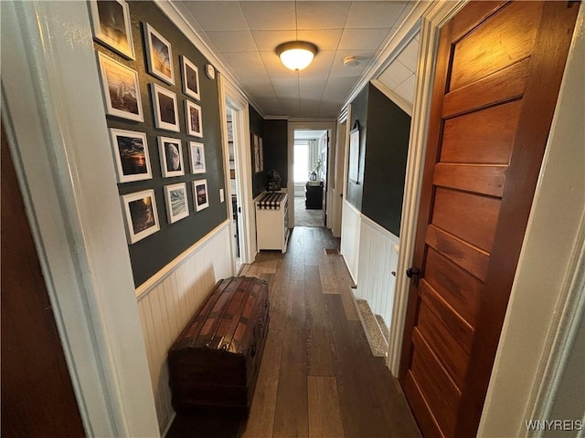 hall with ornamental molding and dark hardwood / wood-style floors