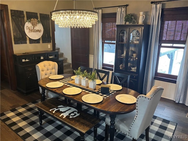 dining area featuring dark hardwood / wood-style floors and a chandelier