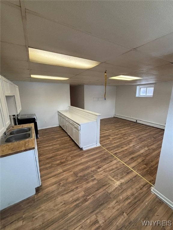 kitchen with white cabinetry, a paneled ceiling, sink, and dark wood-type flooring