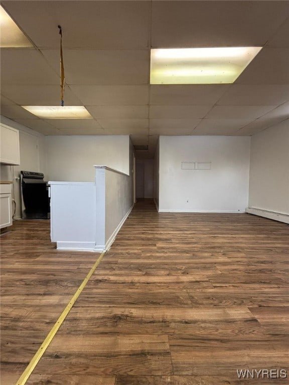 unfurnished room featuring dark hardwood / wood-style flooring and a drop ceiling