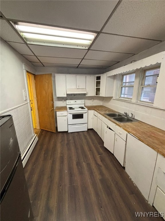 kitchen with white electric range, dark wood-type flooring, white cabinetry, a drop ceiling, and a baseboard radiator