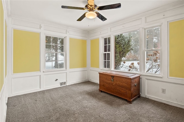 unfurnished sunroom featuring ceiling fan