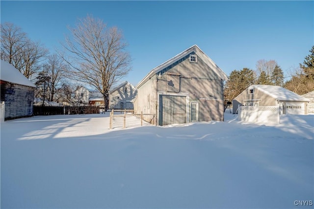 yard covered in snow featuring an outdoor structure