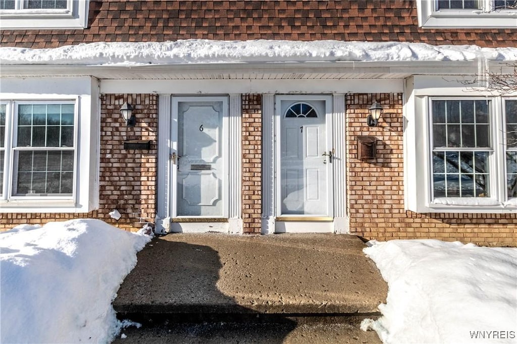 view of snow covered property entrance