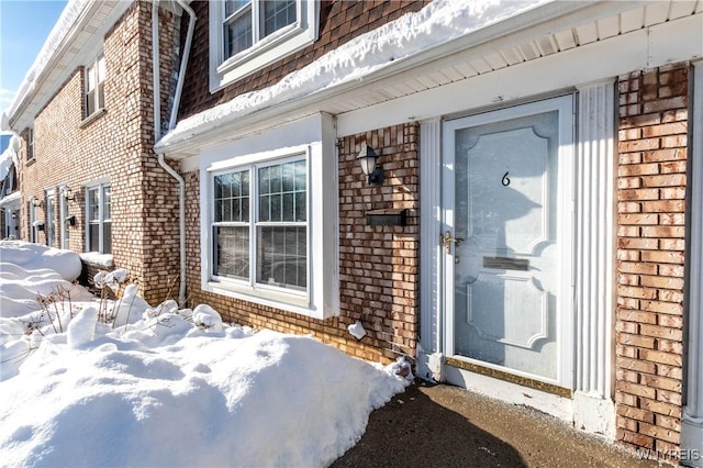 view of snow covered property entrance