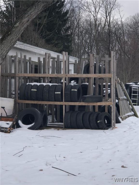 view of snow covered rear of property