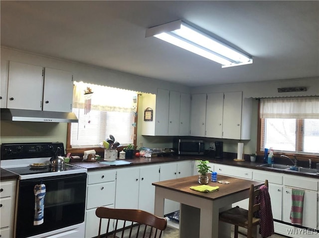 kitchen featuring black electric range oven, sink, and white cabinets