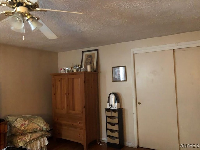 sitting room featuring ceiling fan and a textured ceiling