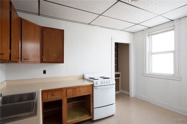 kitchen with plenty of natural light, sink, white electric range oven, and a paneled ceiling