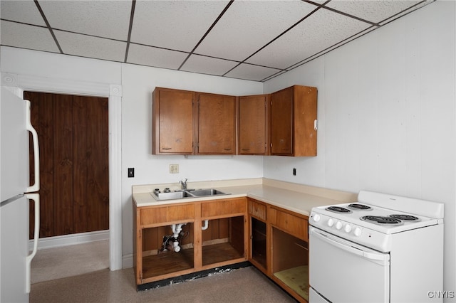 kitchen with white appliances, sink, and a drop ceiling