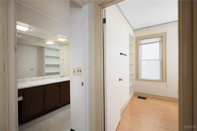 bathroom with vanity and wood-type flooring