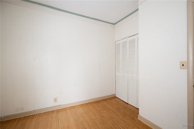 unfurnished bedroom featuring hardwood / wood-style flooring and a closet