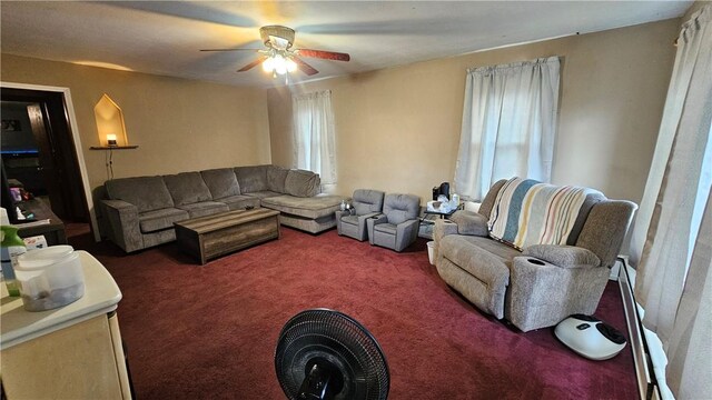 carpeted living room with a ceiling fan
