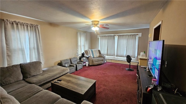 carpeted living area featuring a baseboard radiator, a ceiling fan, and a textured ceiling