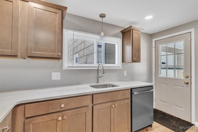 kitchen featuring pendant lighting, dishwasher, sink, light stone countertops, and light wood-type flooring