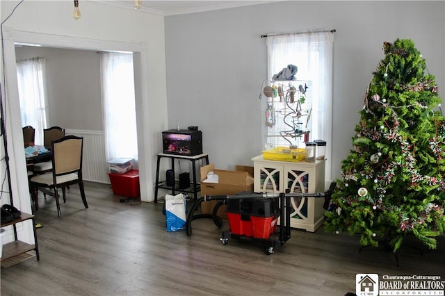 dining area with hardwood / wood-style floors and crown molding