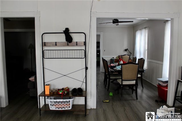 dining room with dark hardwood / wood-style flooring and crown molding