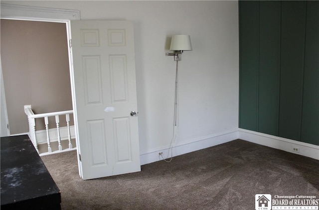 unfurnished bedroom with dark colored carpet