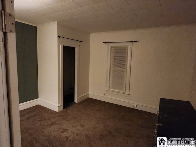 unfurnished room with dark carpet