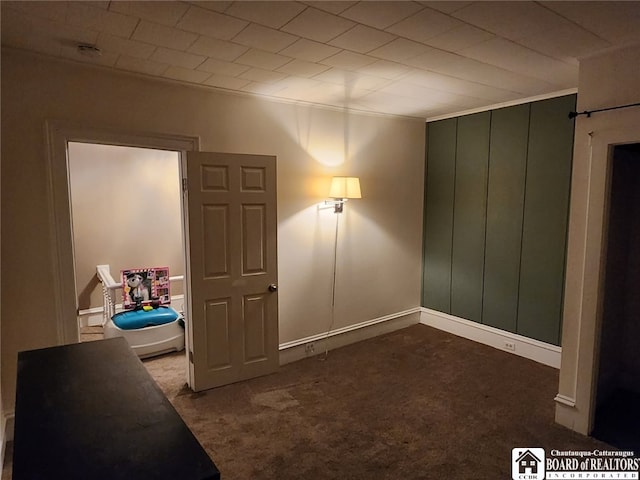 bedroom with dark colored carpet