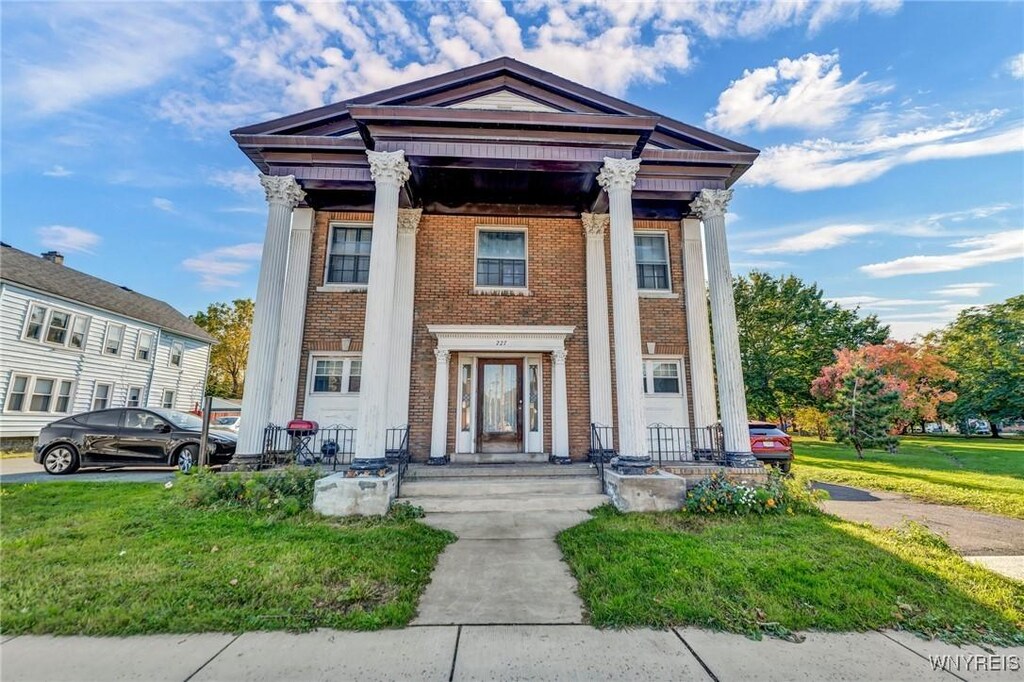 227 Abbott Rd, Buffalo, NY 14220 - neoclassical home with a front lawn and brick siding