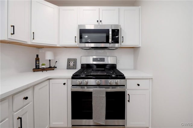 kitchen featuring tasteful backsplash, appliances with stainless steel finishes, and white cabinets