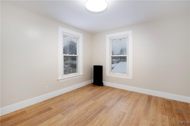 unfurnished room featuring light hardwood / wood-style floors