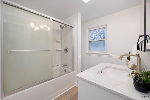 bathroom with vanity, bath / shower combo with glass door, and wood-type flooring