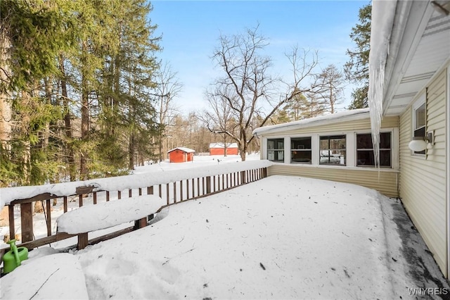 yard covered in snow featuring a deck