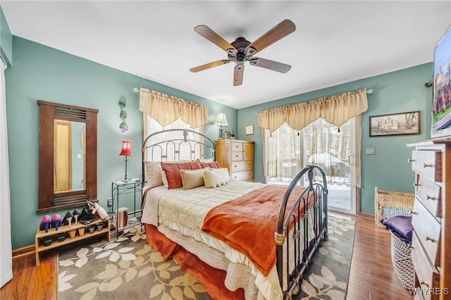 bedroom featuring hardwood / wood-style flooring, ceiling fan, and access to outside