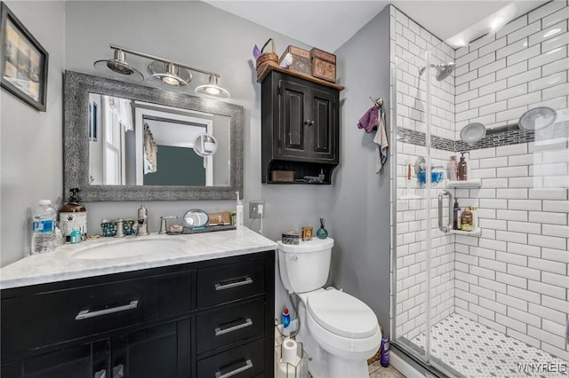 bathroom with vanity, toilet, and an enclosed shower