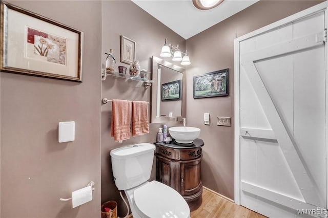 bathroom featuring hardwood / wood-style flooring, vanity, and toilet