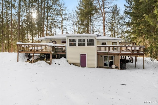 snow covered property with a wooden deck